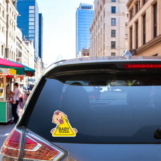 Baby on Board" sticker featuring a baby girl with a pink bow, holding a yellow sign with black writing